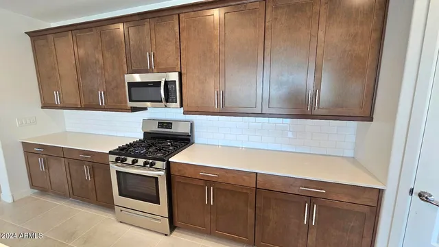 a kitchen with wooden cabinets and a stove top oven