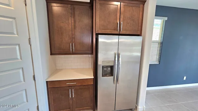 a kitchen with a refrigerator and cabinets