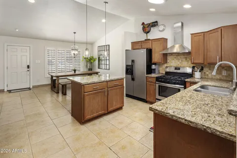a kitchen with stainless steel appliances granite countertop a stove oven and a refrigerator
