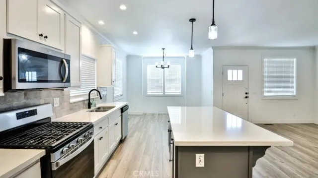 a kitchen with a sink stove and microwave