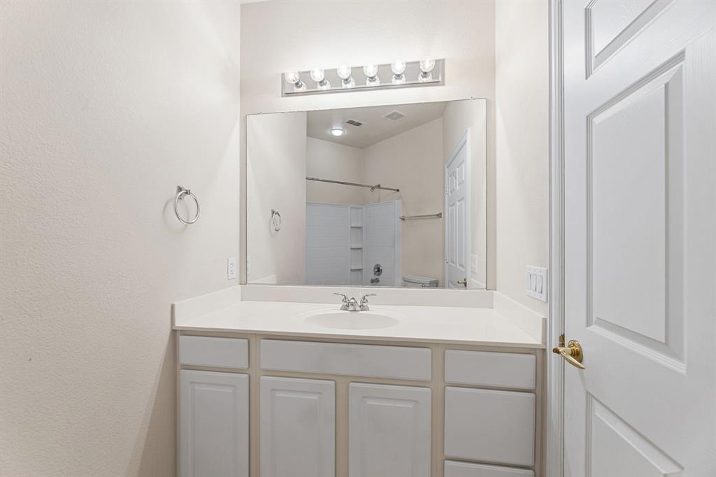 719 Scenic Ranch Circle Fairview, TX 75069 - Photo 30 of 36 a bathroom with a sink a mirror and a vanity
