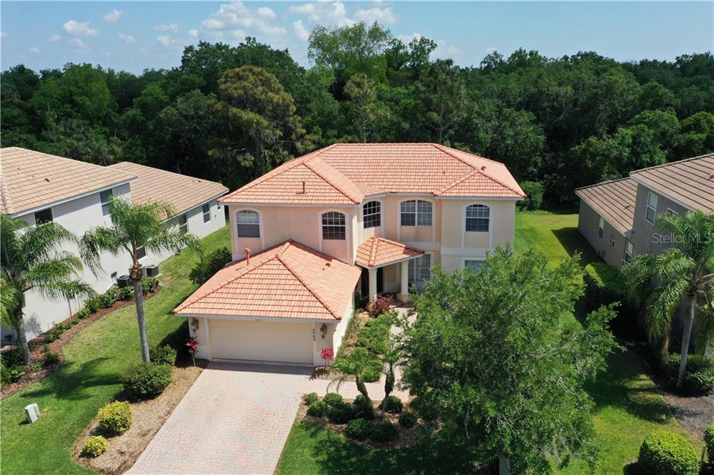 Barrel tile roof, extra long driveway, and a wonderful curb appeal... River Place your new Florida home!Guest bedroom and bathroom on the ground floor!