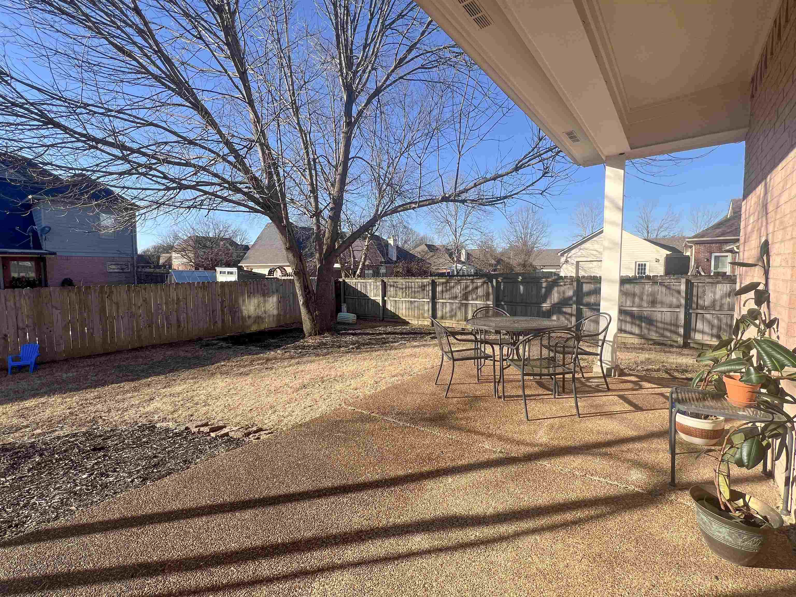 503 Old Collierville-arlin Road Collierville, TN 38017 - Photo 36 of 37 a view of a backyard with table and chairs with wooden fence