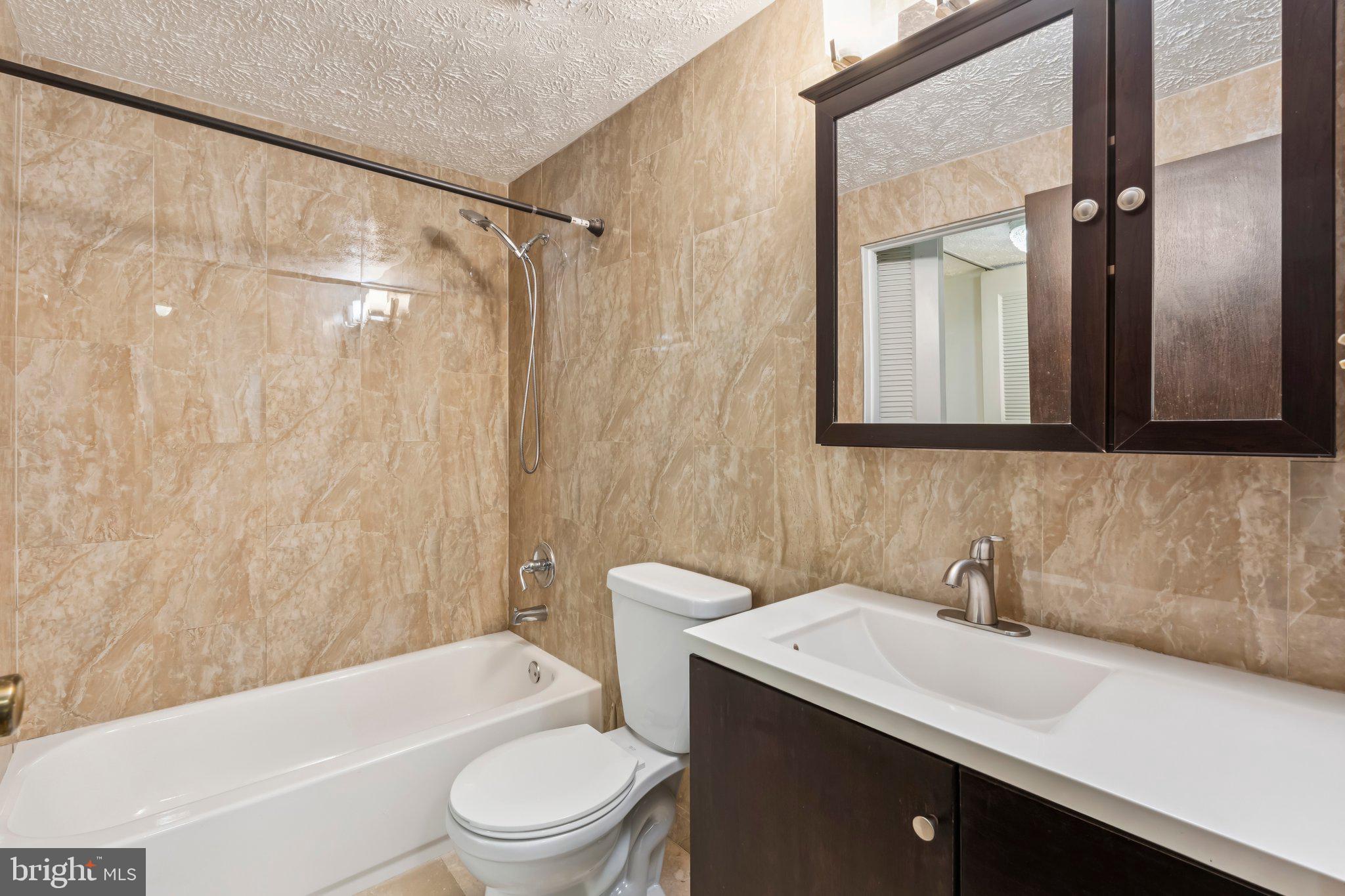 8277 Crestmont Circle Springfield, VA 22153 - Photo 12 of 23 a bathroom with a sink a toilet and a bathtub