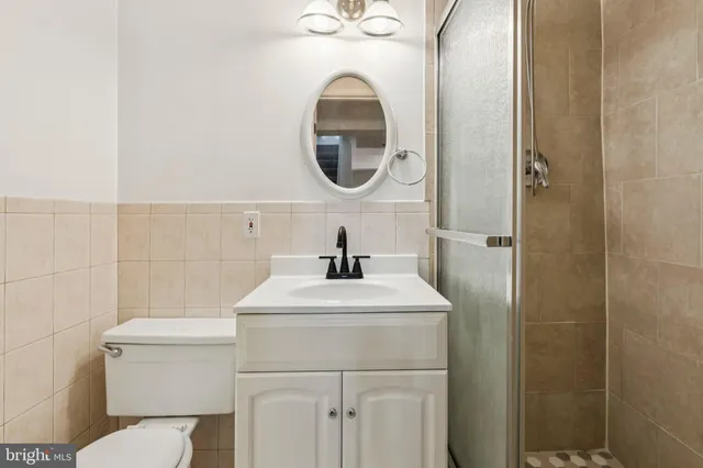 a bathroom with a sink mirror and toilet