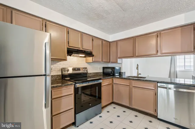 a kitchen with a white cabinets and white appliances