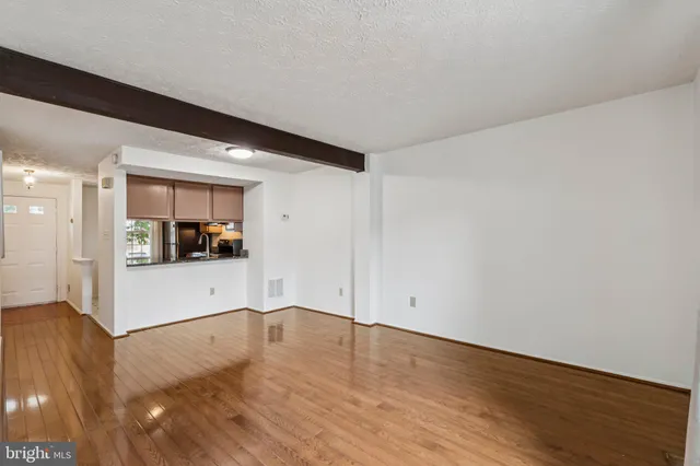 a view of a room with wooden floor and a sink