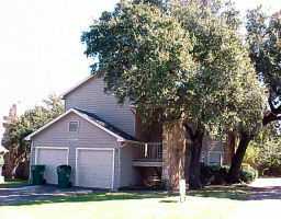 8809 Schick Road Austin, TX 78729 - Photo 1 of 1 a front view of a house with a yard