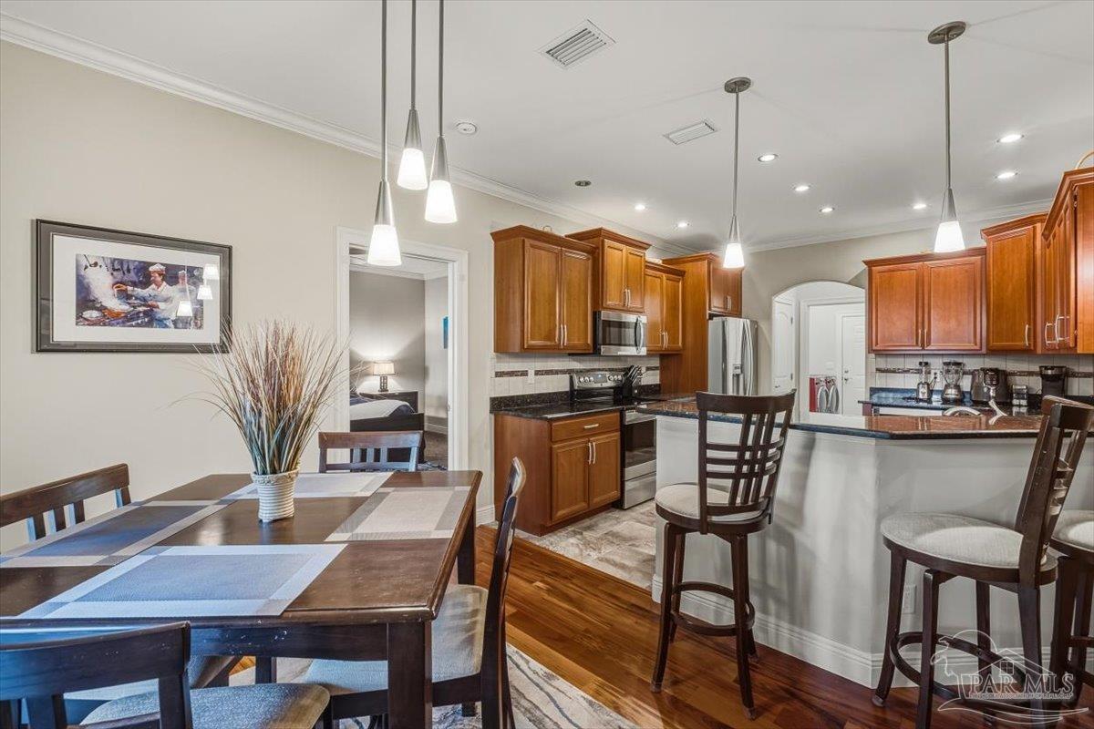 8756 Olivera Street Navarre, FL 32566 - Photo 12 of 41 a view of a dining room with furniture