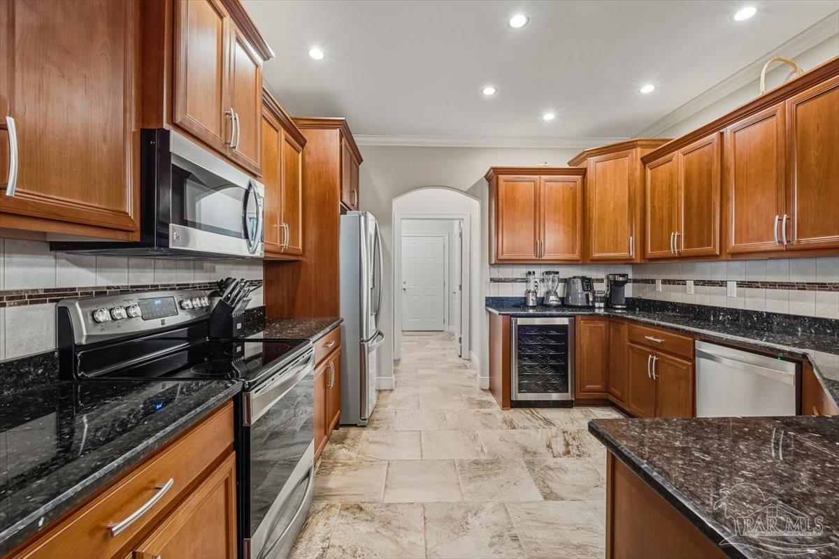 8756 Olivera Street Navarre, FL 32566 - Photo 14 of 41 a kitchen with stainless steel appliances granite countertop a stove a sink and a microwave