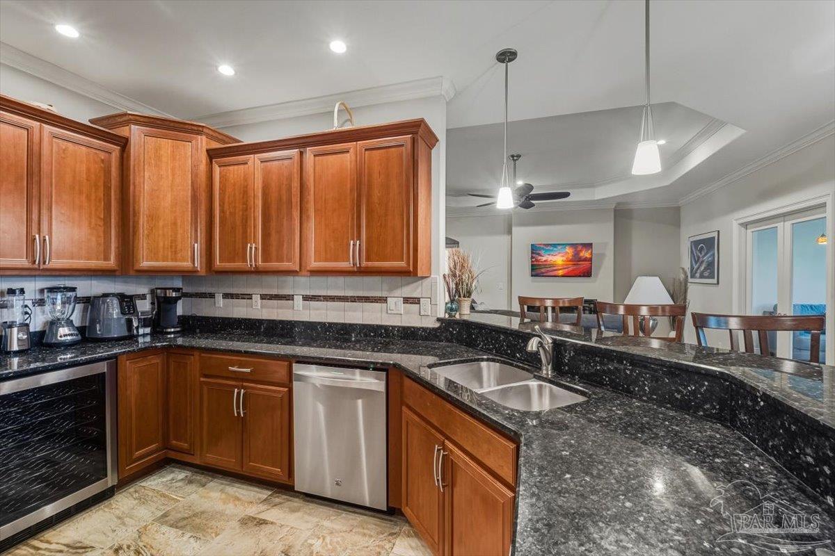 8756 Olivera Street Navarre, FL 32566 - Photo 15 of 41 a kitchen with granite countertop a sink stainless steel appliances and cabinets