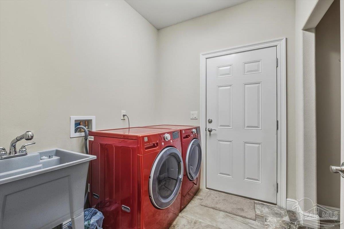8756 Olivera Street Navarre, FL 32566 - Photo 18 of 41 a utility room with dryer and washer