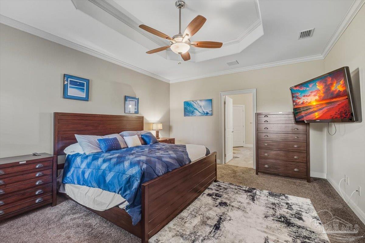 8756 Olivera Street Navarre, FL 32566 - Photo 20 of 41 a bedroom with a bed and a flat screen tv