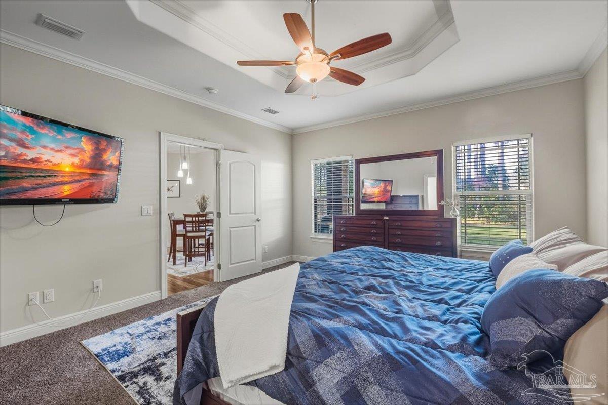 8756 Olivera Street Navarre, FL 32566 - Photo 22 of 41 a living room with a bed furniture and a flat screen tv