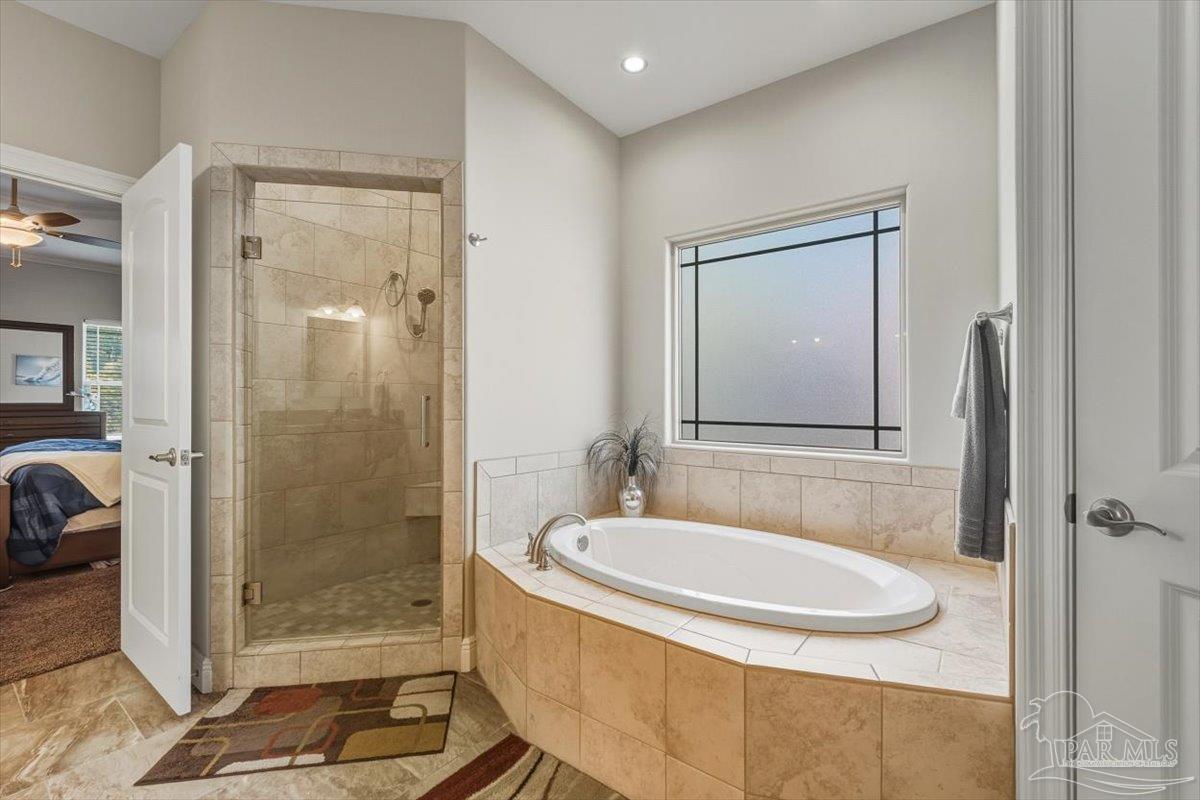 8756 Olivera Street Navarre, FL 32566 - Photo 27 of 41 a bathroom with a granite countertop sink a mirror and shower