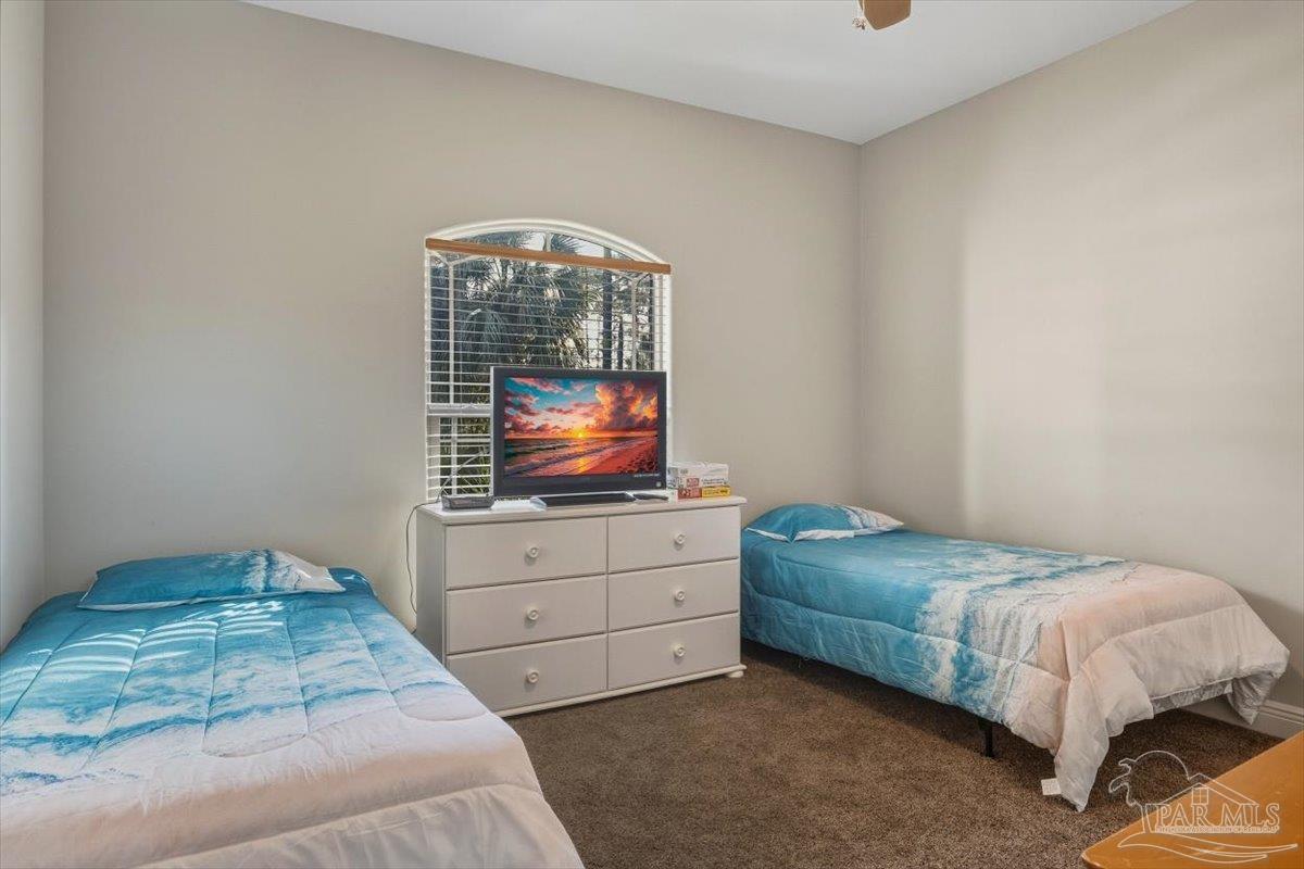 8756 Olivera Street Navarre, FL 32566 - Photo 28 of 41 a bedroom with a bed and window