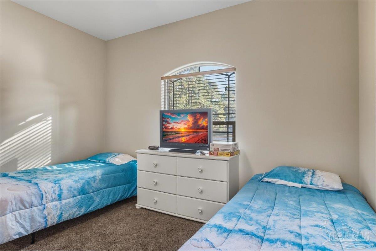 8756 Olivera Street Navarre, FL 32566 - Photo 29 of 41 a bedroom with a bed and window