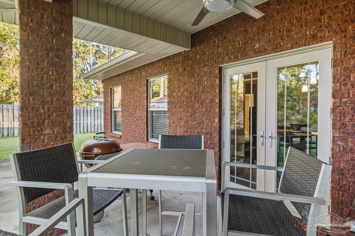 8756 Olivera Street Navarre, FL 32566 - Photo 35 of 41 a view of a dining room with furniture window and outside view