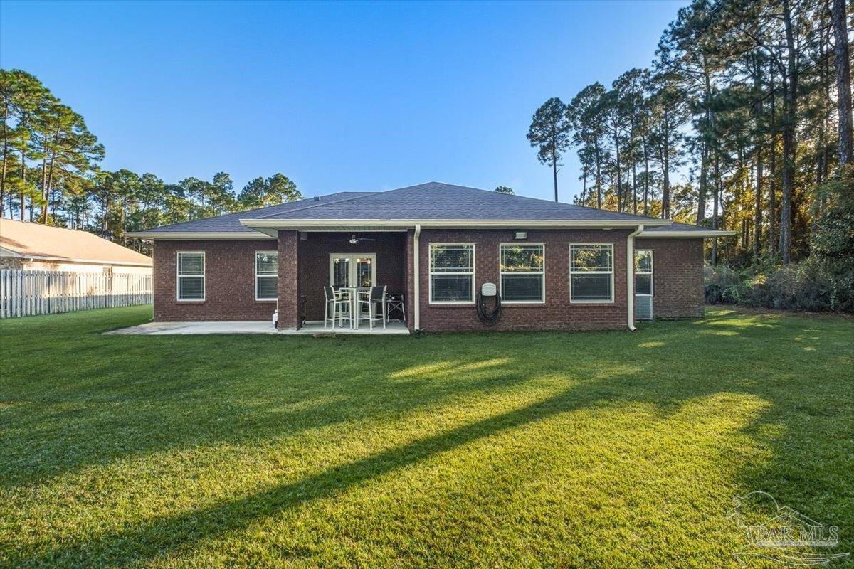 8756 Olivera Street Navarre, FL 32566 - Photo 39 of 41 a view of a house with a backyard