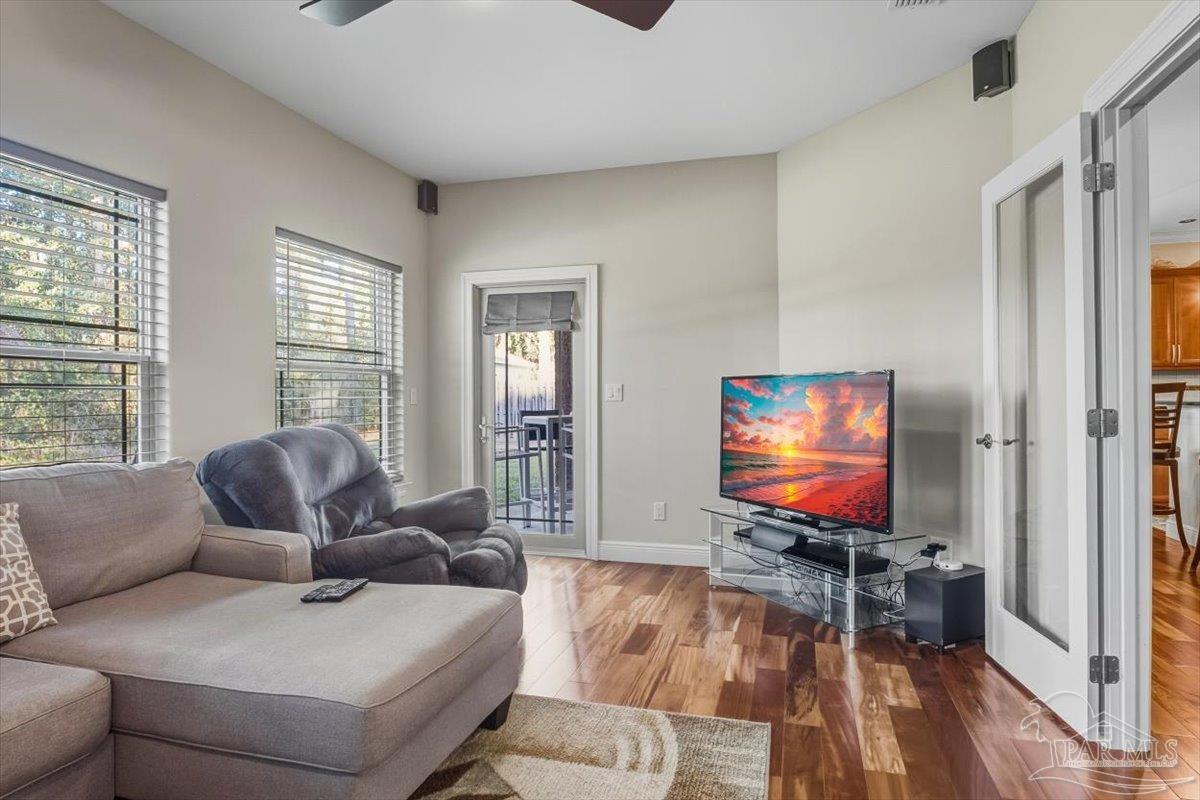 8756 Olivera Street Navarre, FL 32566 - Photo 4 of 41 a living room with furniture and a flat screen tv