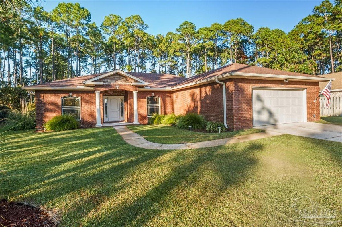 8756 Olivera Street Navarre, FL 32566 - Photo 41 of 41 a front view of a house with a yard