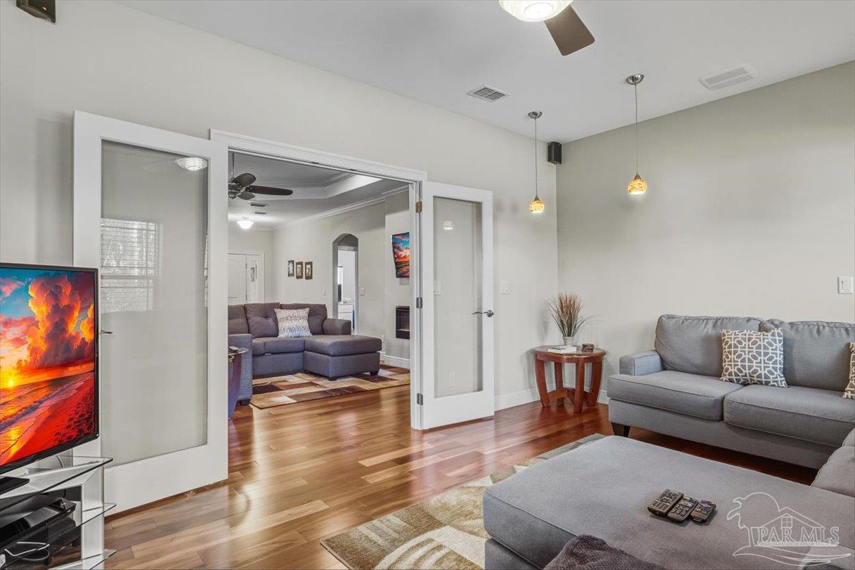 8756 Olivera Street Navarre, FL 32566 - Photo 6 of 41 a living room with furniture and a flat screen tv