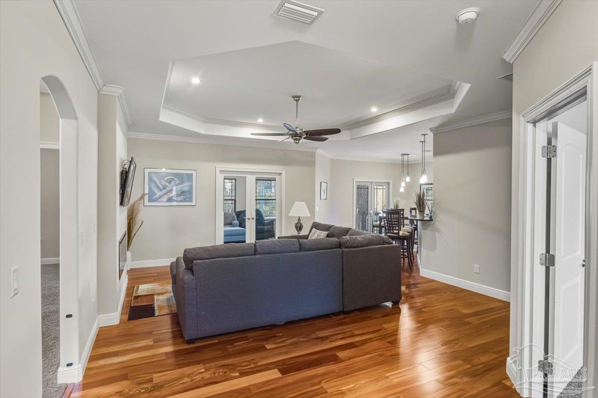 8756 Olivera Street Navarre, FL 32566 - Photo 7 of 41 a living room with furniture and a wooden floor