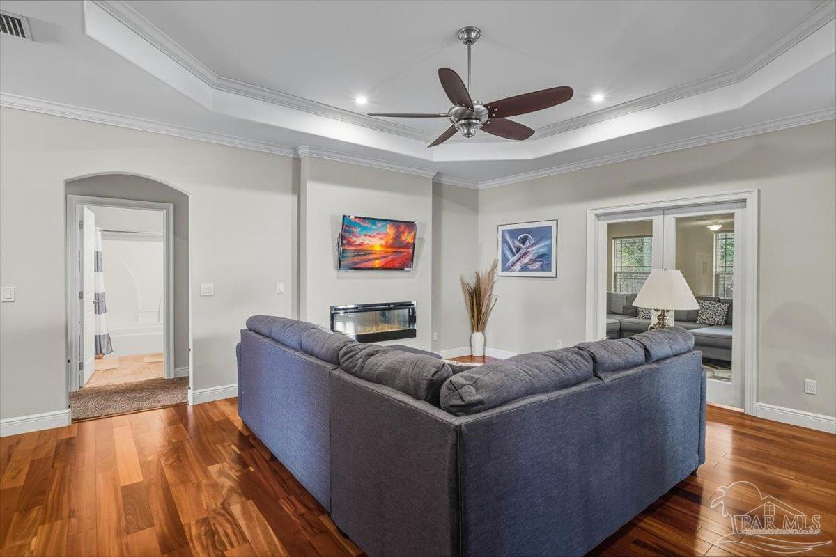 8756 Olivera Street Navarre, FL 32566 - Photo 8 of 41 a living room with furniture and a wooden floor