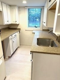 70 Clay Pond Road, Unit B Bourne, MA 02532 - Photo 3 of 9 a kitchen with granite countertop white cabinets and a sink