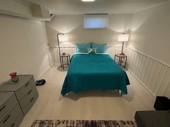 70 Clay Pond Road, Unit B Bourne, MA 02532 - Photo 5 of 9 a bedroom with a bed and a large mirror on the dresser