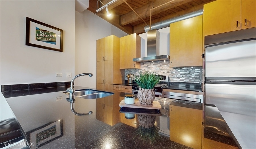 1040 West Adams Street, Unit 347 Chicago, IL 60607 - Photo 12 of 29 a dining room with furniture and wooden floor