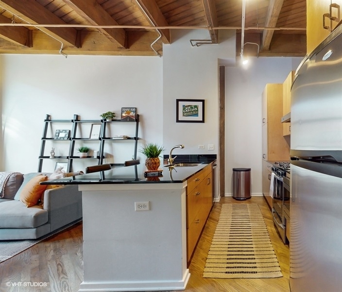 1040 West Adams Street, Unit 347 Chicago, IL 60607 - Photo 13 of 29 a view of a kitchen with furniture and a rug