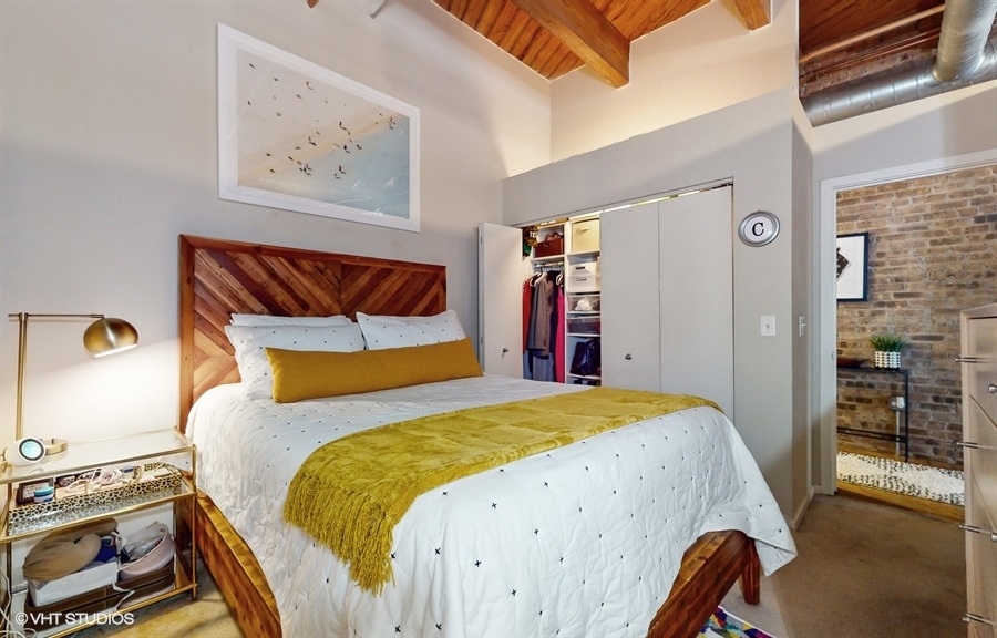 1040 West Adams Street, Unit 347 Chicago, IL 60607 - Photo 14 of 29 a bedroom with a bed and wooden floor