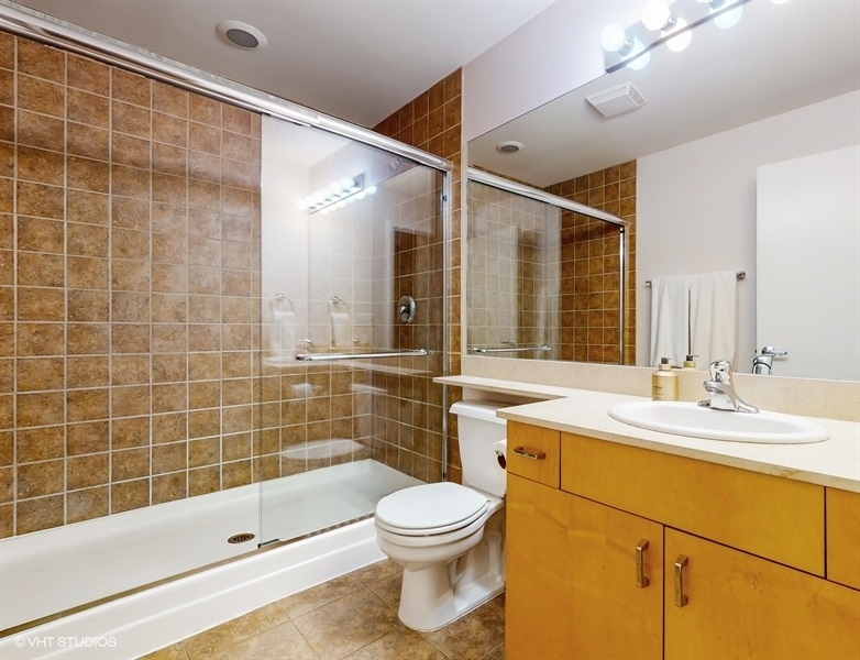 1040 West Adams Street, Unit 347 Chicago, IL 60607 - Photo 19 of 29 a bathroom with a sink a toilet and shower
