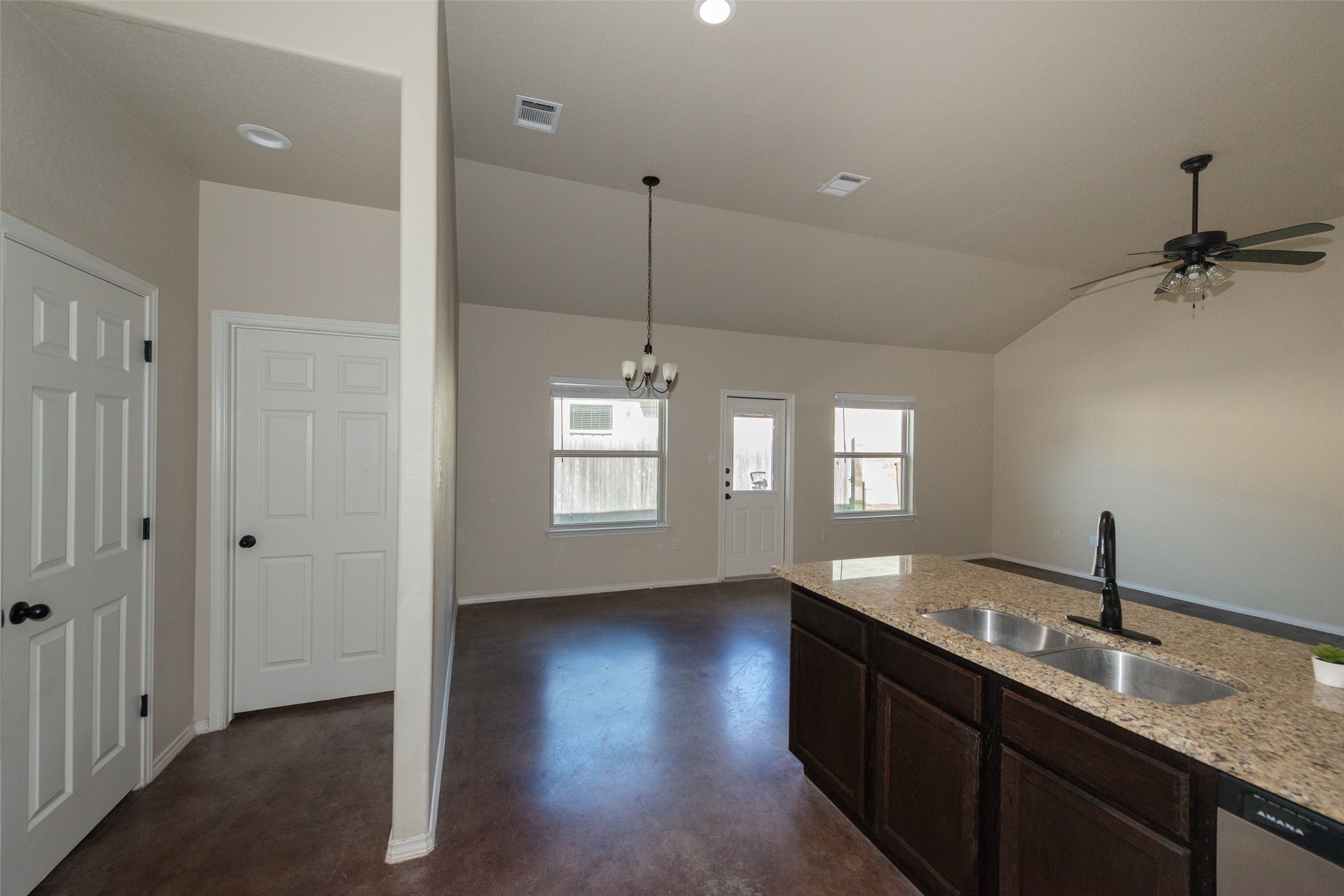 245 Joanne Loop, Unit B Buda, TX 78610 - Photo 12 of 33 Looking back from kitchen range to the other side. Immediate door on left is pantry and farther door leads to laundry room