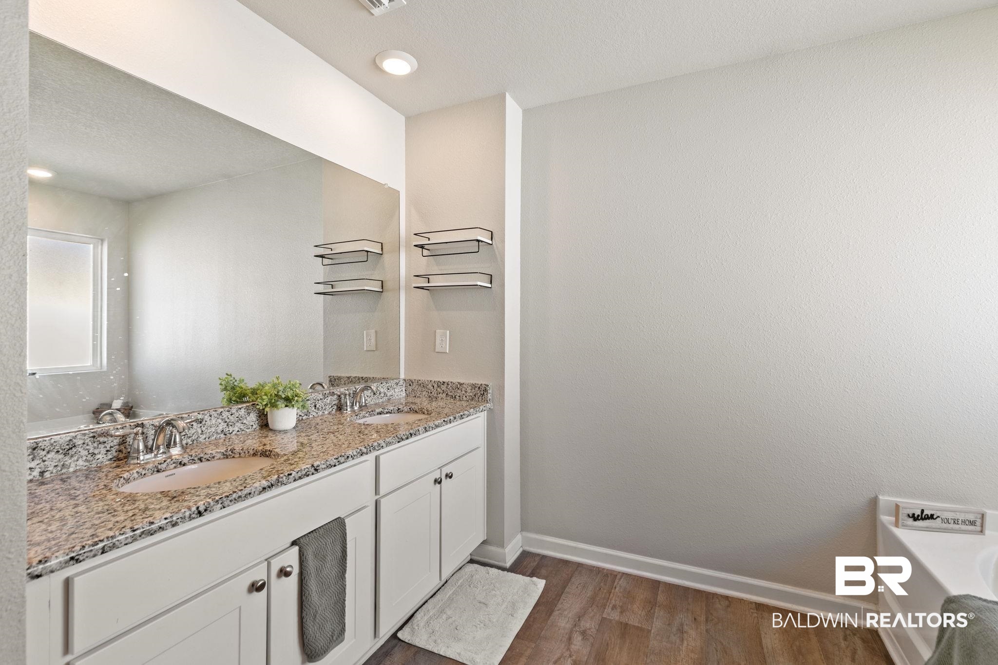 32234 Calder Court Daphne, AL 36527 - Photo 20 of 32 Bathroom with double vanity, dark wood-type flooring, a garden tub, a textured ceiling, and recessed lighting