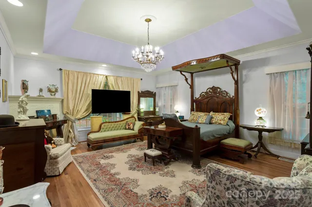 a living room with furniture a flat screen tv and a chandelier
