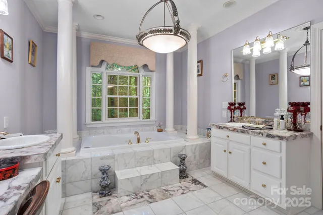 a bathroom with a tub sink and mirror