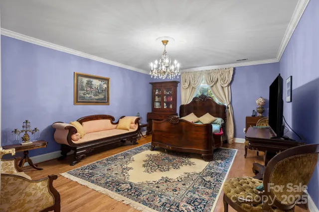 a bed room with furniture and a chandelier