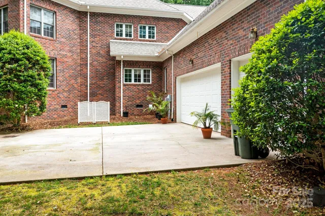 a view of a brick house with potted plants