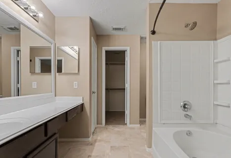 a bathroom with a bathtub and a sink