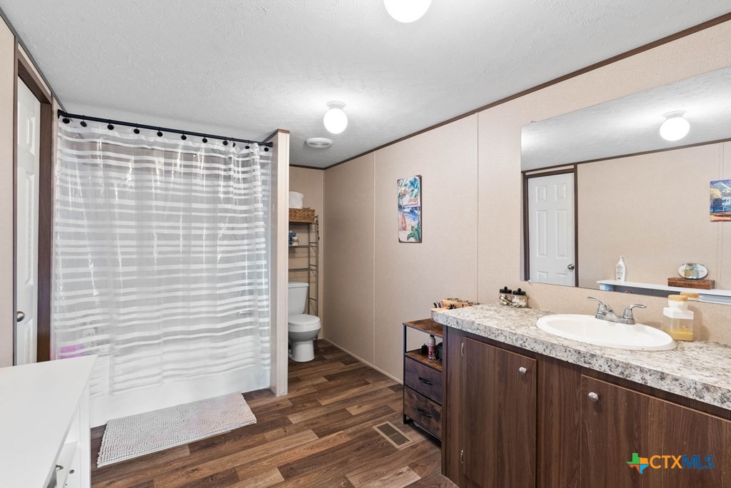 239 Allen M Parks Drive Rockport, TX 78382 - Photo 9 of 29 a bathroom with a granite countertop sink and a mirror