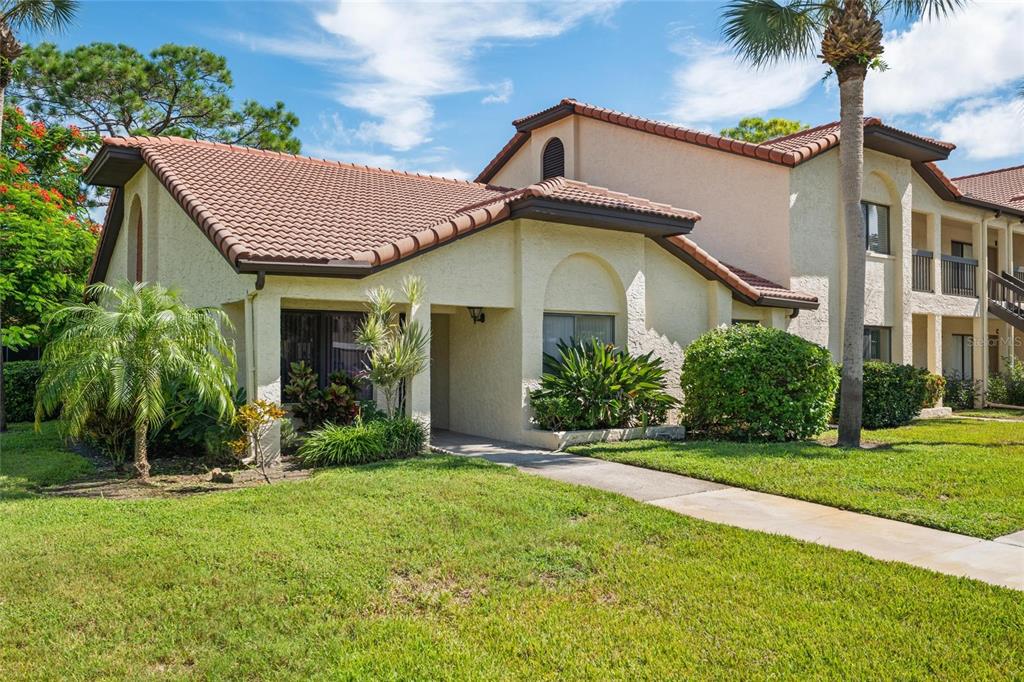 1801 East Lake Road South, Unit 5A Palm Harbor, FL 34685 - Photo 1 of 22 a front view of a house with a yard