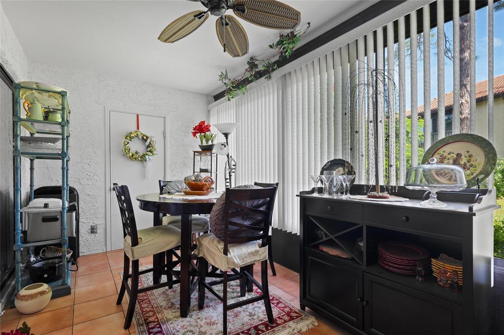 1801 East Lake Road South, Unit 5A Palm Harbor, FL 34685 - Photo 14 of 22 a view of a dining room with furniture and a window