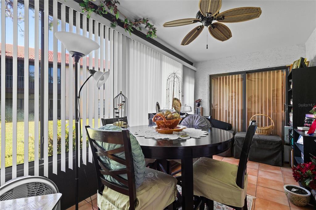 1801 East Lake Road South, Unit 5A Palm Harbor, FL 34685 - Photo 15 of 22 a view of a dining room with furniture window and wooden floor