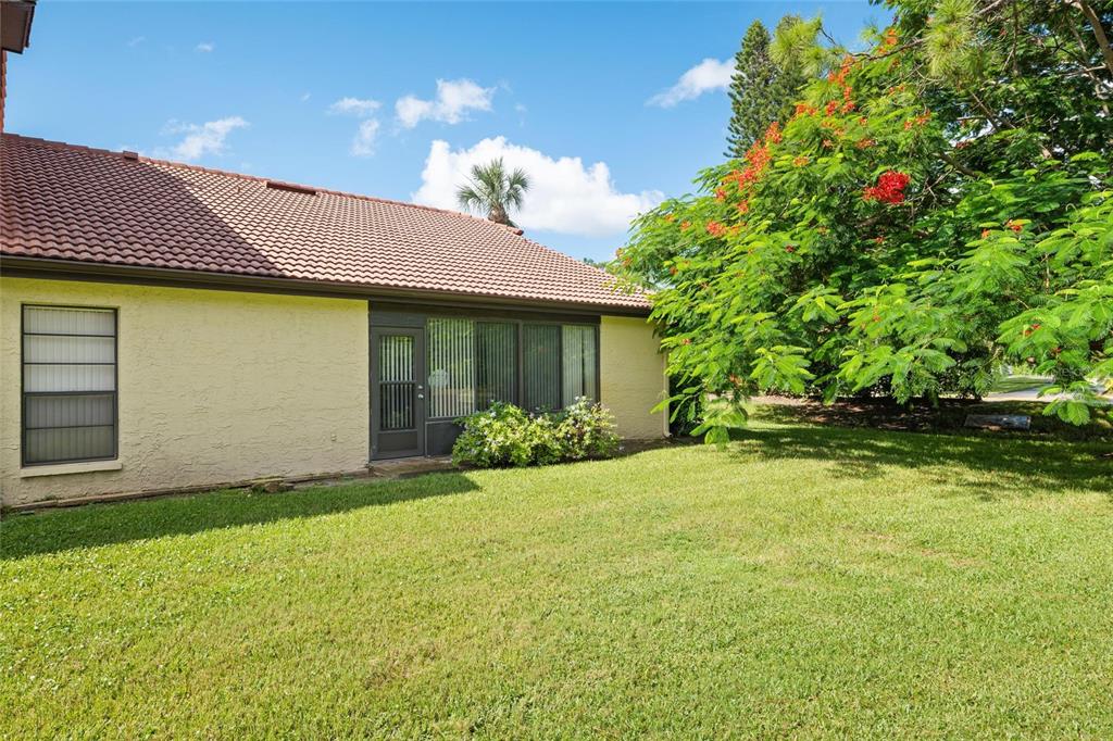 1801 East Lake Road South, Unit 5A Palm Harbor, FL 34685 - Photo 4 of 22 a front view of a house with garden
