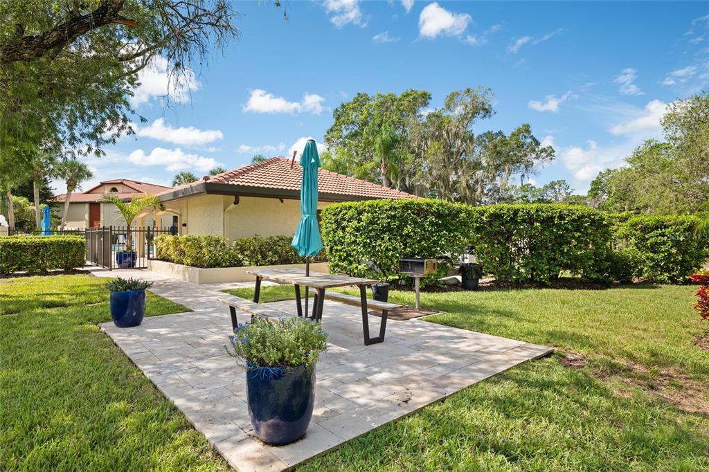 1801 East Lake Road South, Unit 5A Palm Harbor, FL 34685 - Photo 5 of 22 a view of a patio with couches and a table