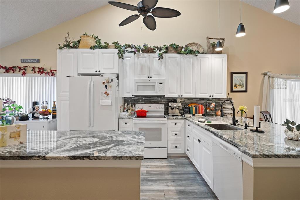 1801 East Lake Road South, Unit 5A Palm Harbor, FL 34685 - Photo 8 of 22 a kitchen with cabinets and window