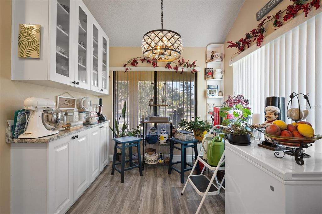 1801 East Lake Road South, Unit 5A Palm Harbor, FL 34685 - Photo 9 of 22 a view of a dining room with furniture and chandelier
