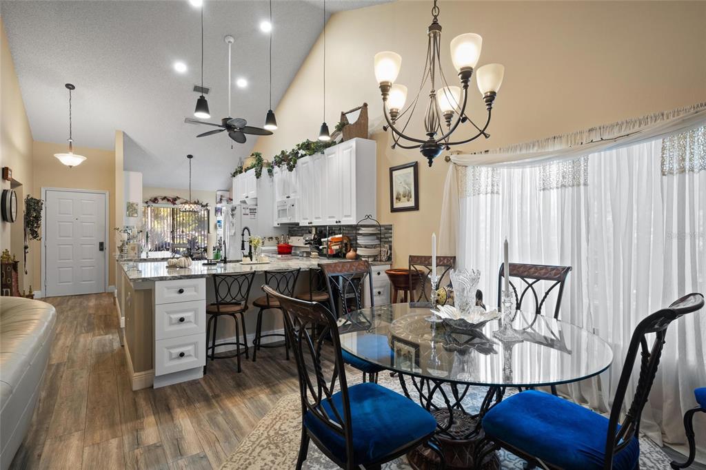 1801 East Lake Road South, Unit 5A Palm Harbor, FL 34685 - Photo 10 of 22 a view of a dining room with furniture and wooden floor